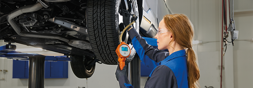 A Subaru technician checking tire pressure. | Vann York Subaru in Asheboro NC