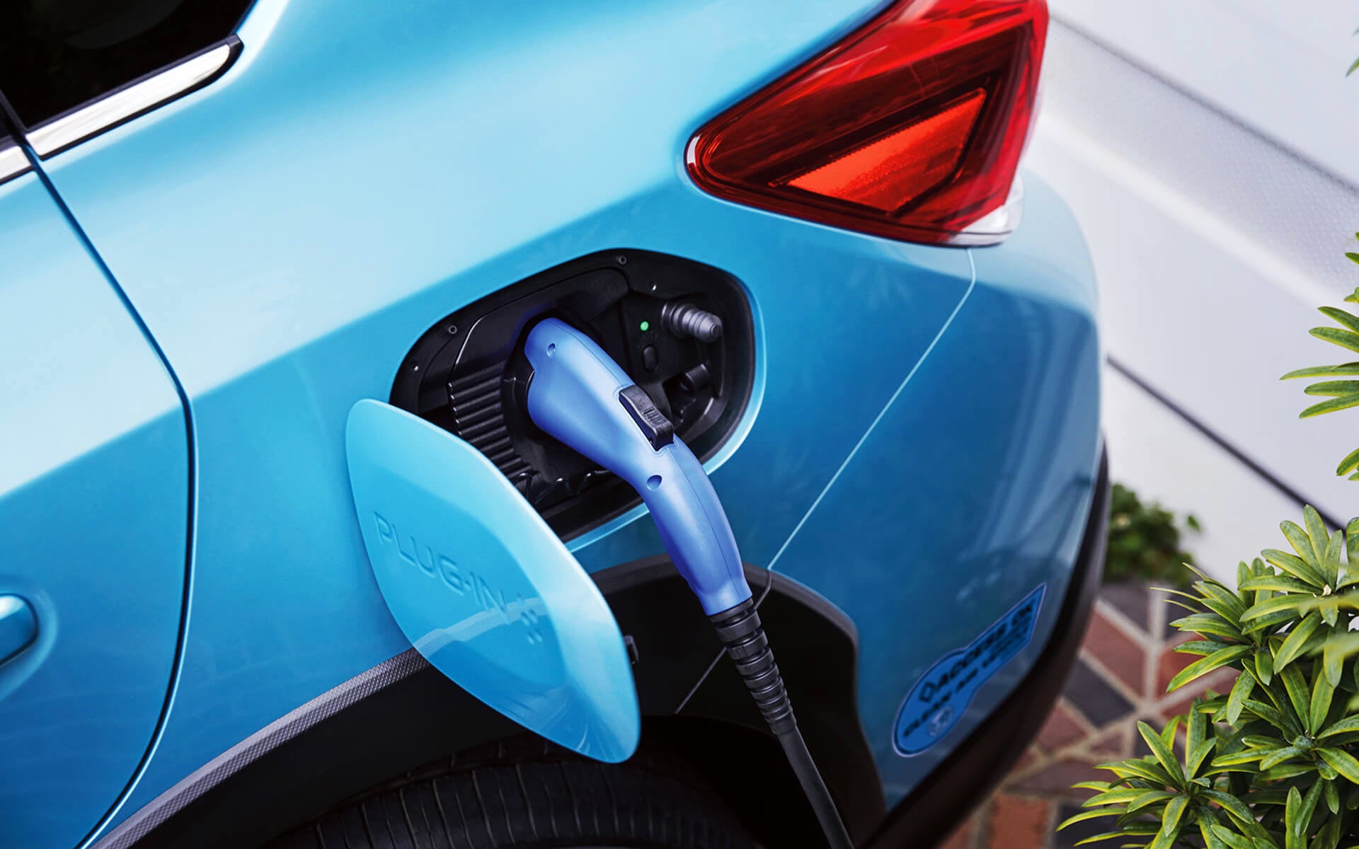 A close-up of the Subaru Crosstrek Hybrid's charging port with charging cable plugged in | Vann York Subaru in Asheboro NC
